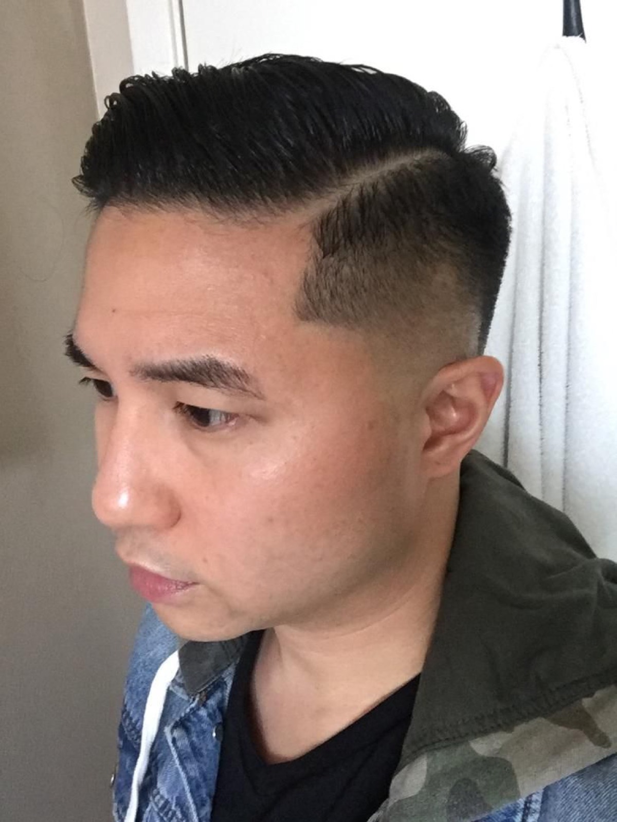 Hard part and combed pompadour over a high bald fade