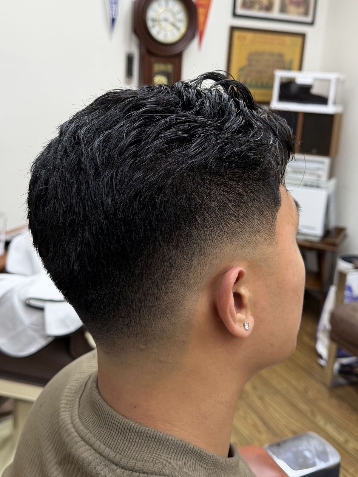 A mid skin fade blended into a textured crop
